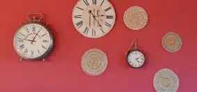 three round analog clocks and round gray mats